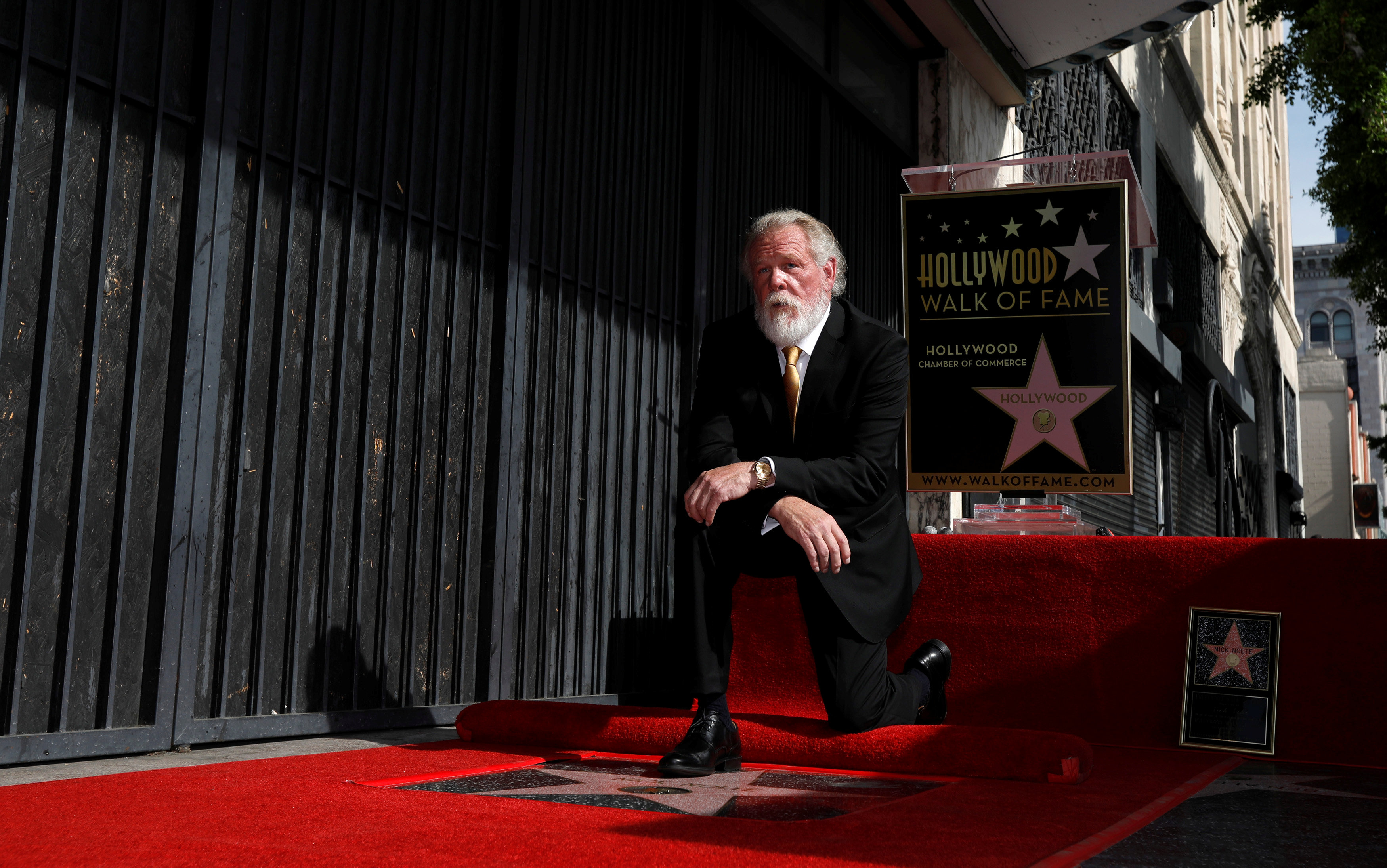 Actor Nick Nolte poses on his star after it was unveiled on the Hollywood Walk of Fame in Los Angeles, California, U.S., November 20, 2017. REUTERS/Mario Anzuoni